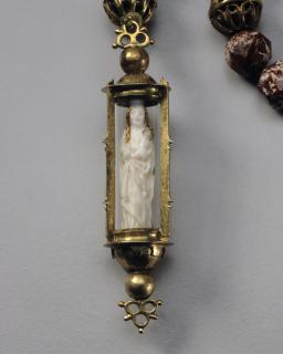 Statuette; enclosed in a rosary pendant. (Front)