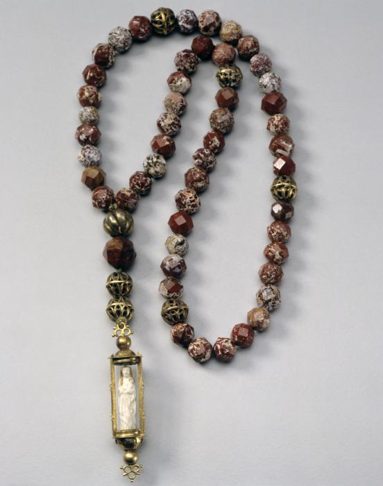 Statuette; enclosed in a rosary pendant. (Front)