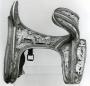 Saddle with reliefs (selle; appliqués) (Side, left)